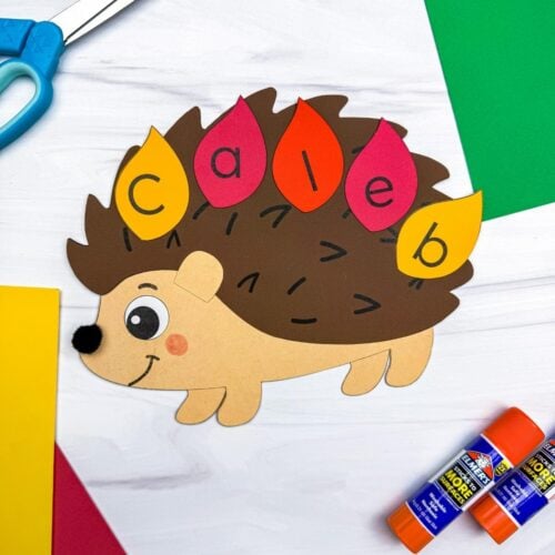 A completed Craft showing a hedgehog name craft with colorful lettered leaves spelling a child’s name.