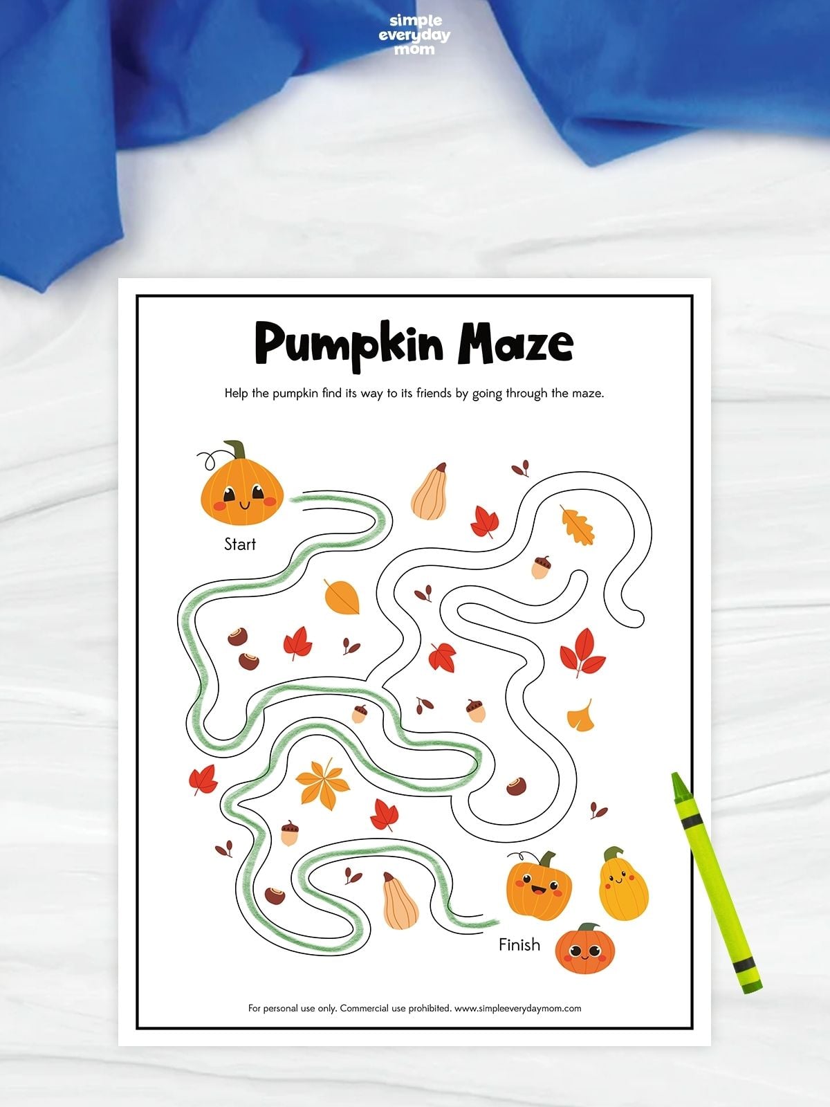 Pumpkin maze worksheet with a green path traced from a smiling pumpkin at the start through autumn leaves and acorns to three pumpkin friends at the finish.