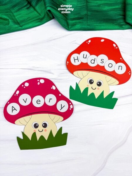 A completed Craft featuring two smiling mushroom name crafts labeled Avery and Hudson with colorful caps and green grass.