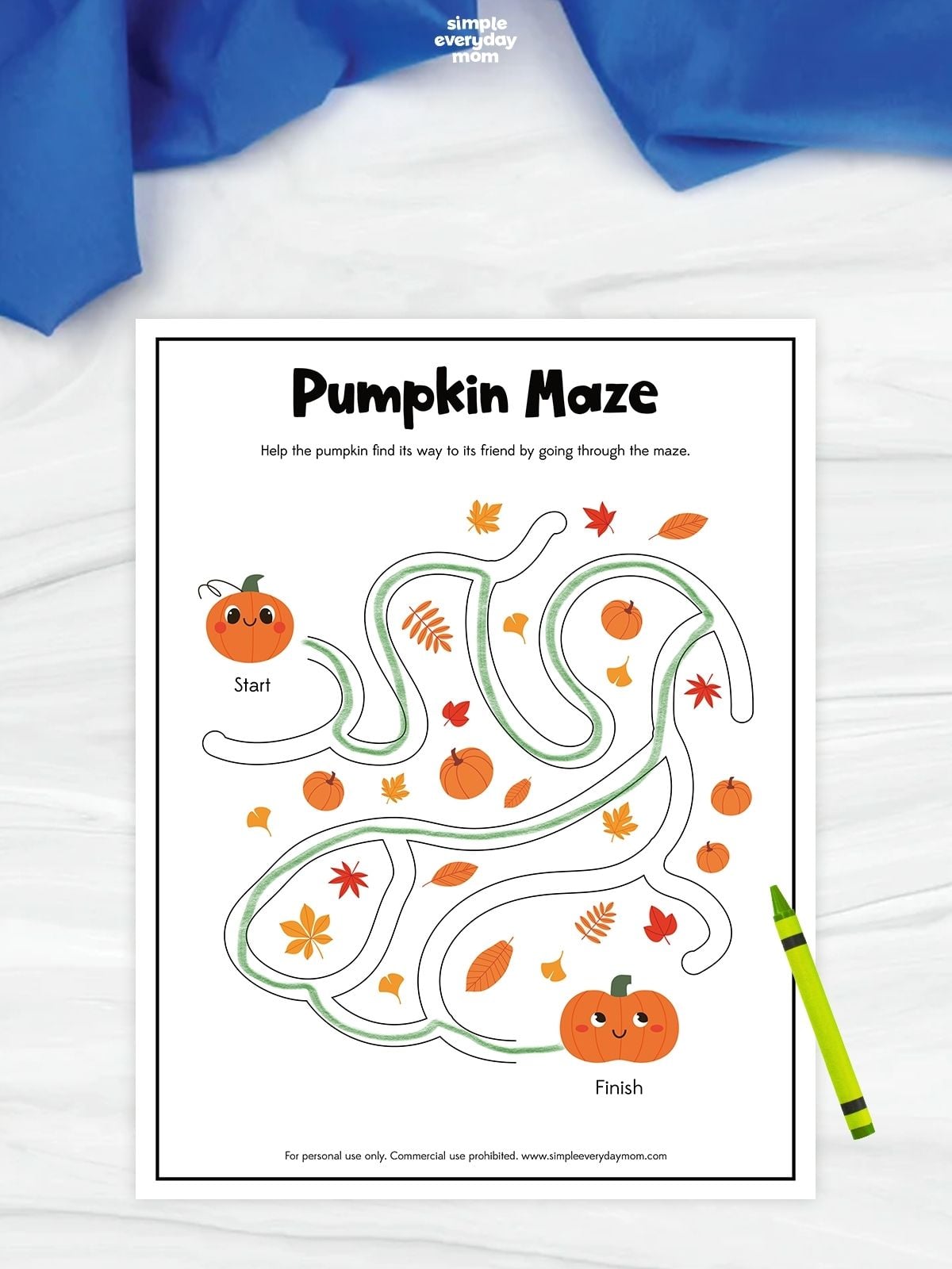 Pumpkin maze worksheet with a green path traced from a smiling pumpkin at the start to another pumpkin at the finish, surrounded by small pumpkins and colorful autumn leaves.