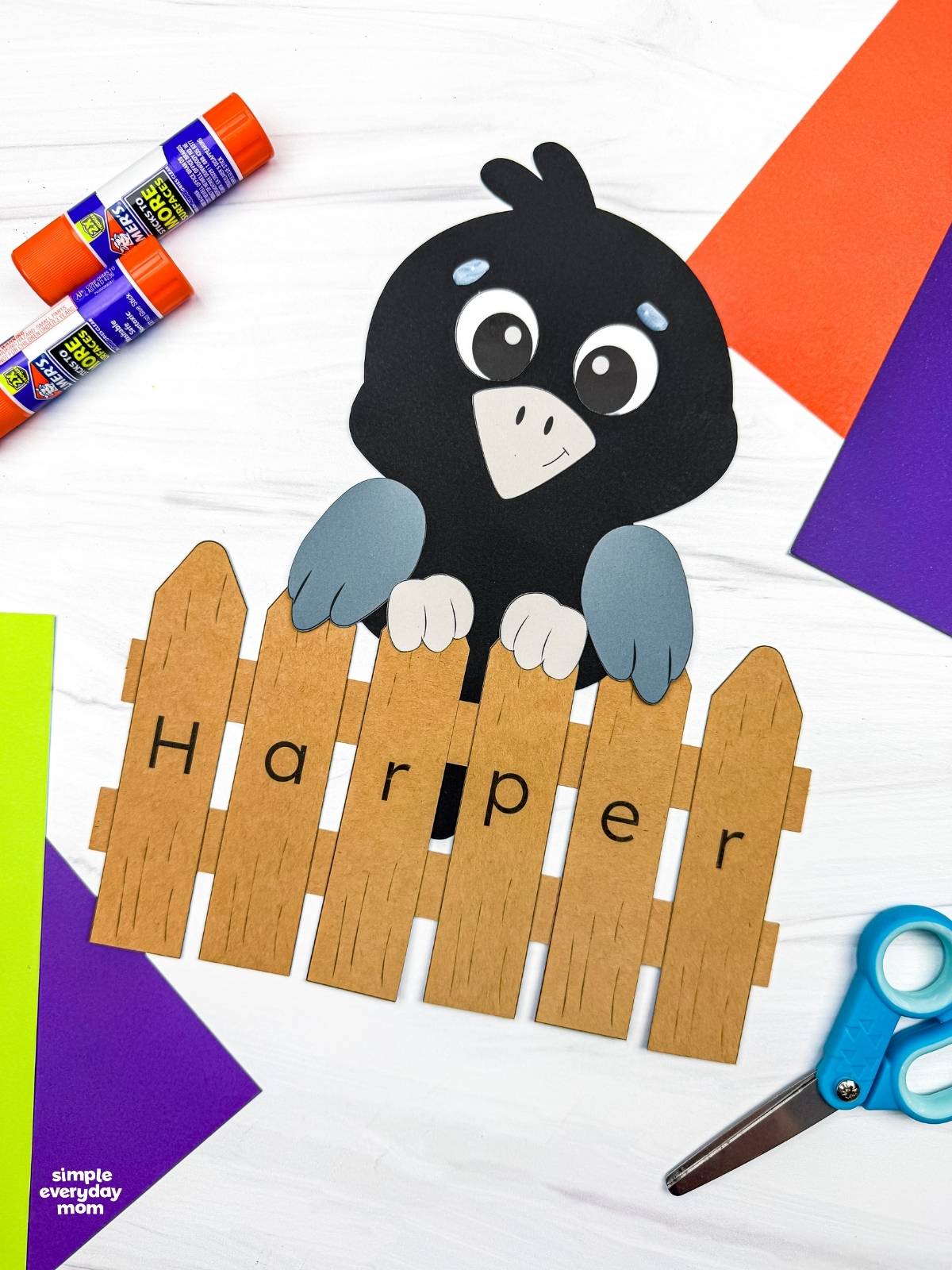 A completed Craft showing a crow perched behind a personalized name fence spelling Harper.