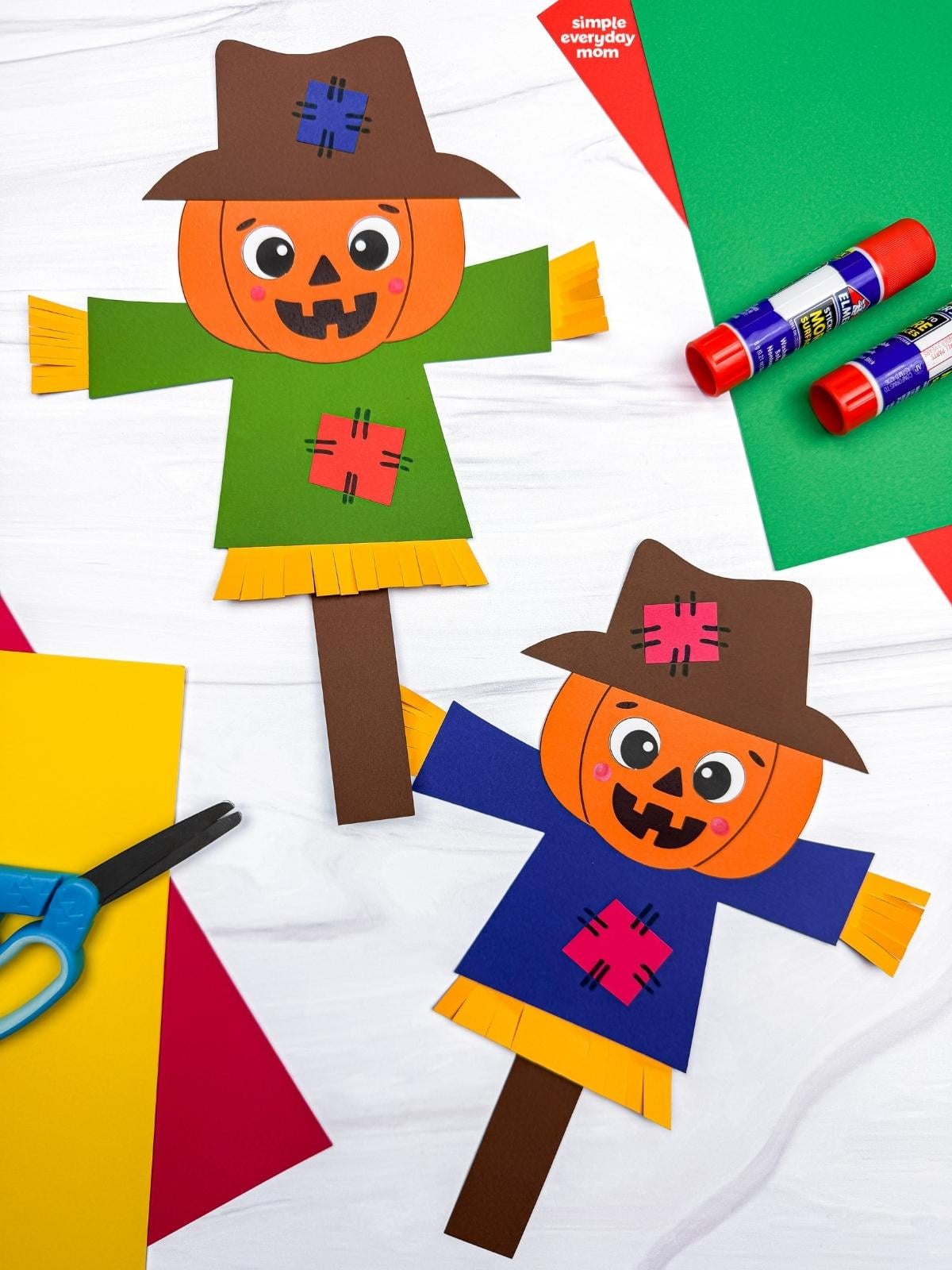 A completed Craft showing two pumpkin head scarecrows with hats, patched shirts, and straw details.