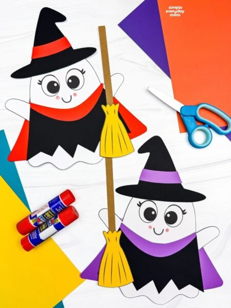 A completed craft showing two Witch Ghost Disguise characters with colorful witch outfits, hats, and brooms surrounded by craft supplies.