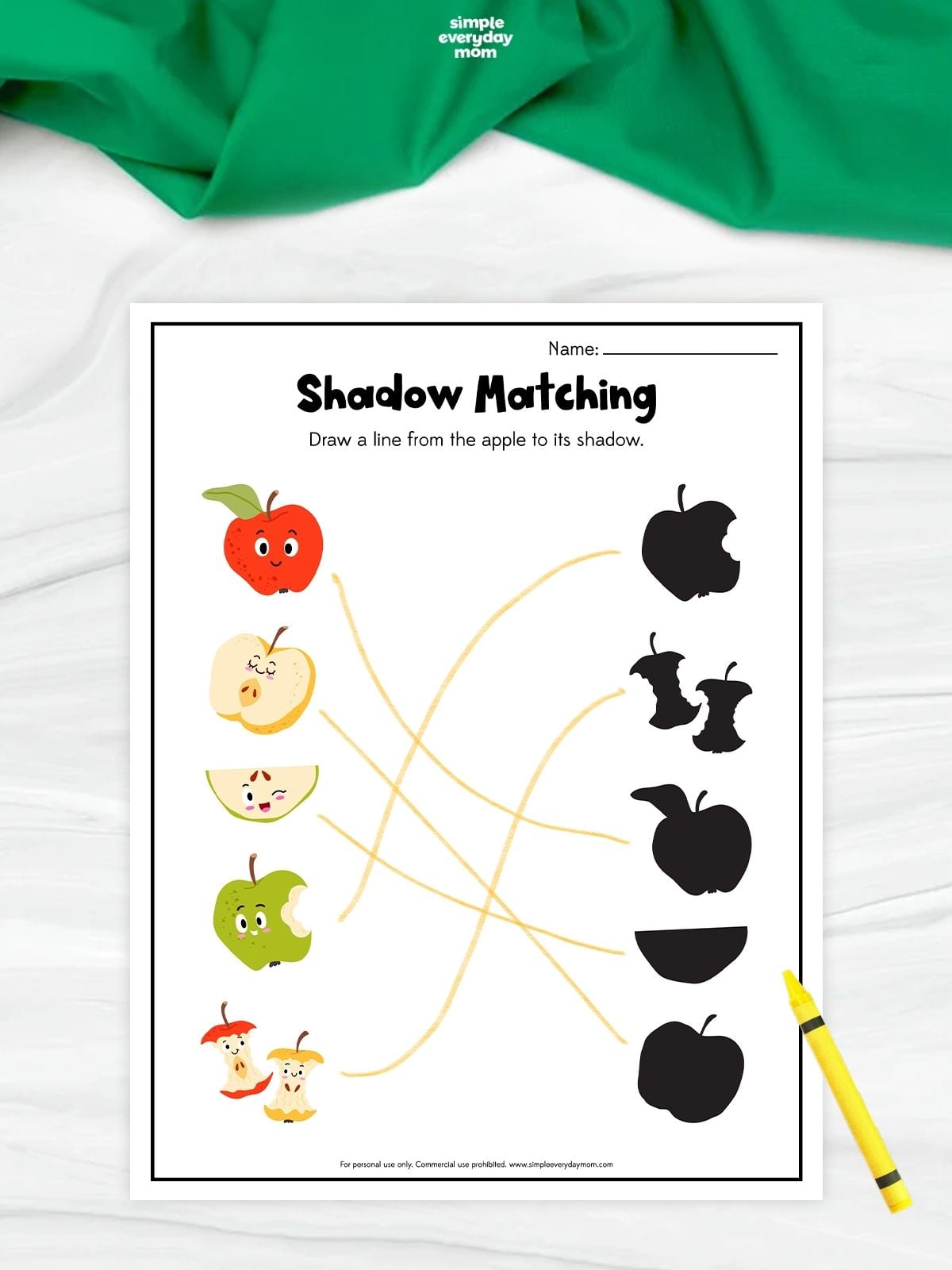 Apple shadow matching worksheet with five apple illustrations connected by lines to their corresponding black silhouettes.