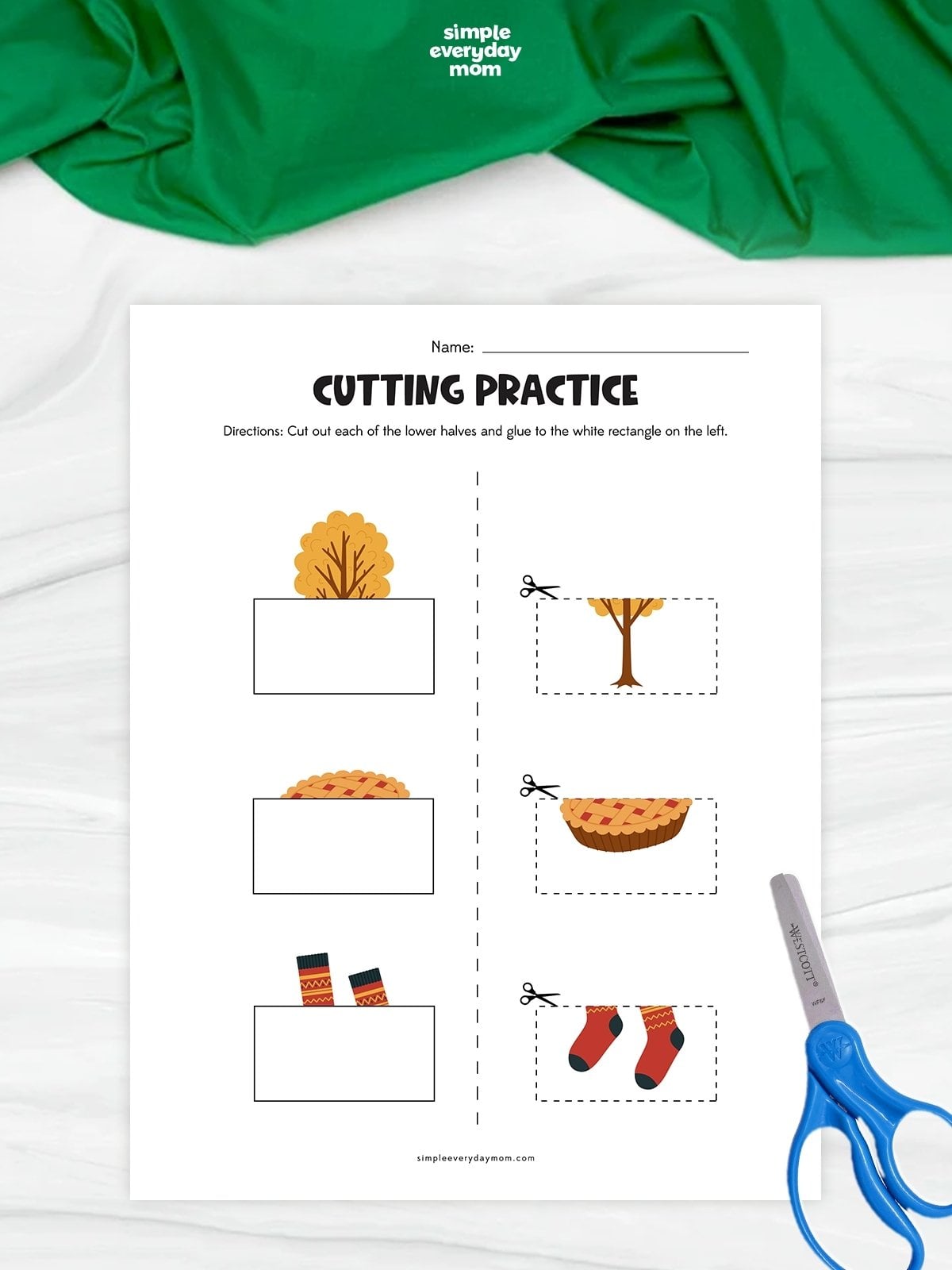 Hands cutting out fall-themed picture halves of a tree, pie, and socks to complete each matching image.