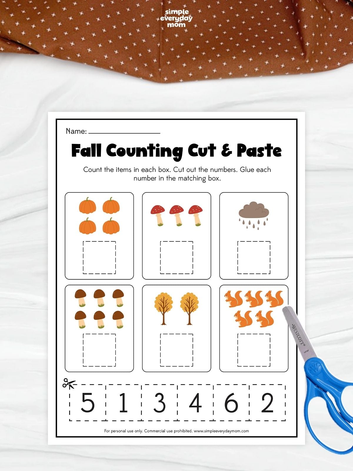 A fall counting cut and paste worksheet for kindergarten featuring pumpkins, mushrooms, trees, squirrels, and number matching practice.