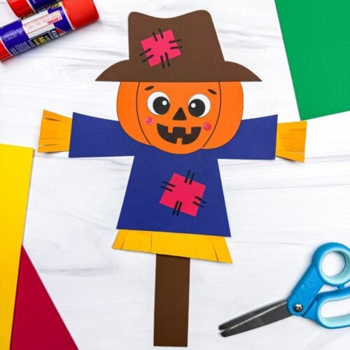 A completed Craft showing a pumpkin head scarecrow with a patched hat, shirt, straw details, and paper stick.
