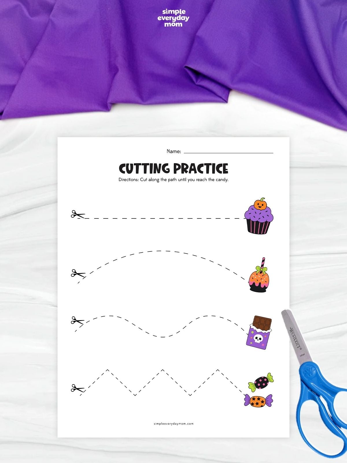 Halloween-themed cutting practice worksheet with dashed straight, curved, wavy, and zigzag paths leading to illustrated treats, including a cupcake, candy apple, chocolate bar, and wrapped candies.