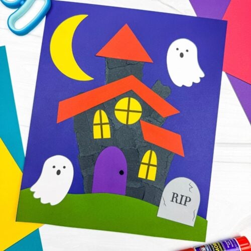 A completed Craft showing a torn paper haunted house with ghosts, a crescent moon, windows, grass, and a headstone.