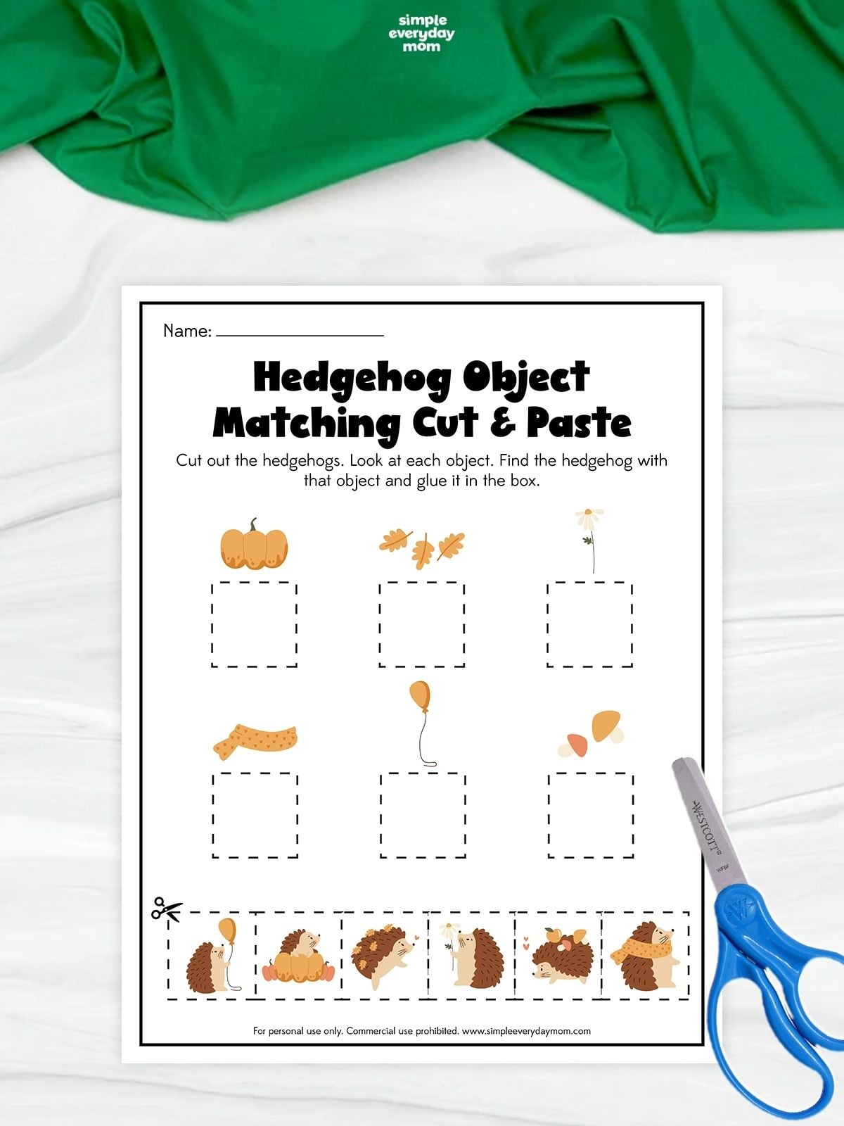 A printable hedgehog object matching cut and paste worksheet with fall pictures for kids to practice matching and fine motor skills.