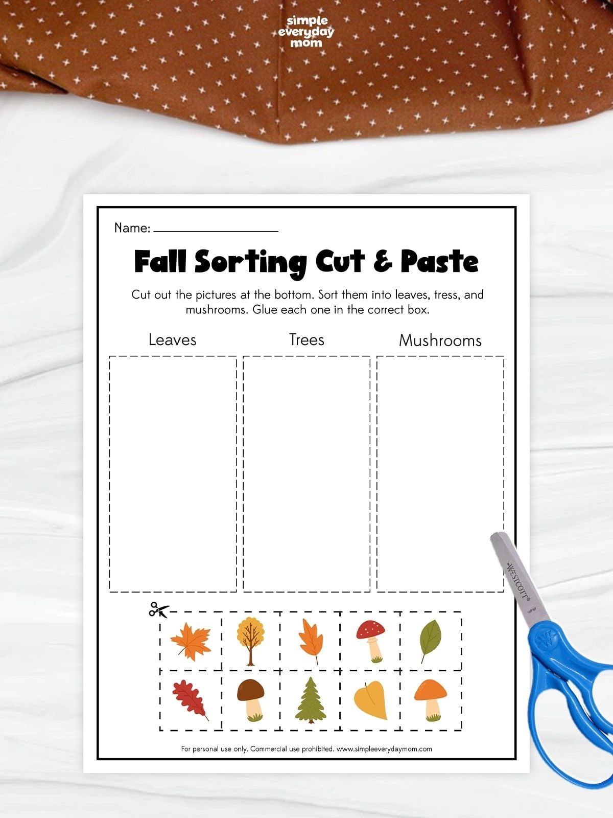 A fall sorting cut and paste worksheet for preschool featuring leaves, trees, and mushrooms to practice classification and fine motor skills.