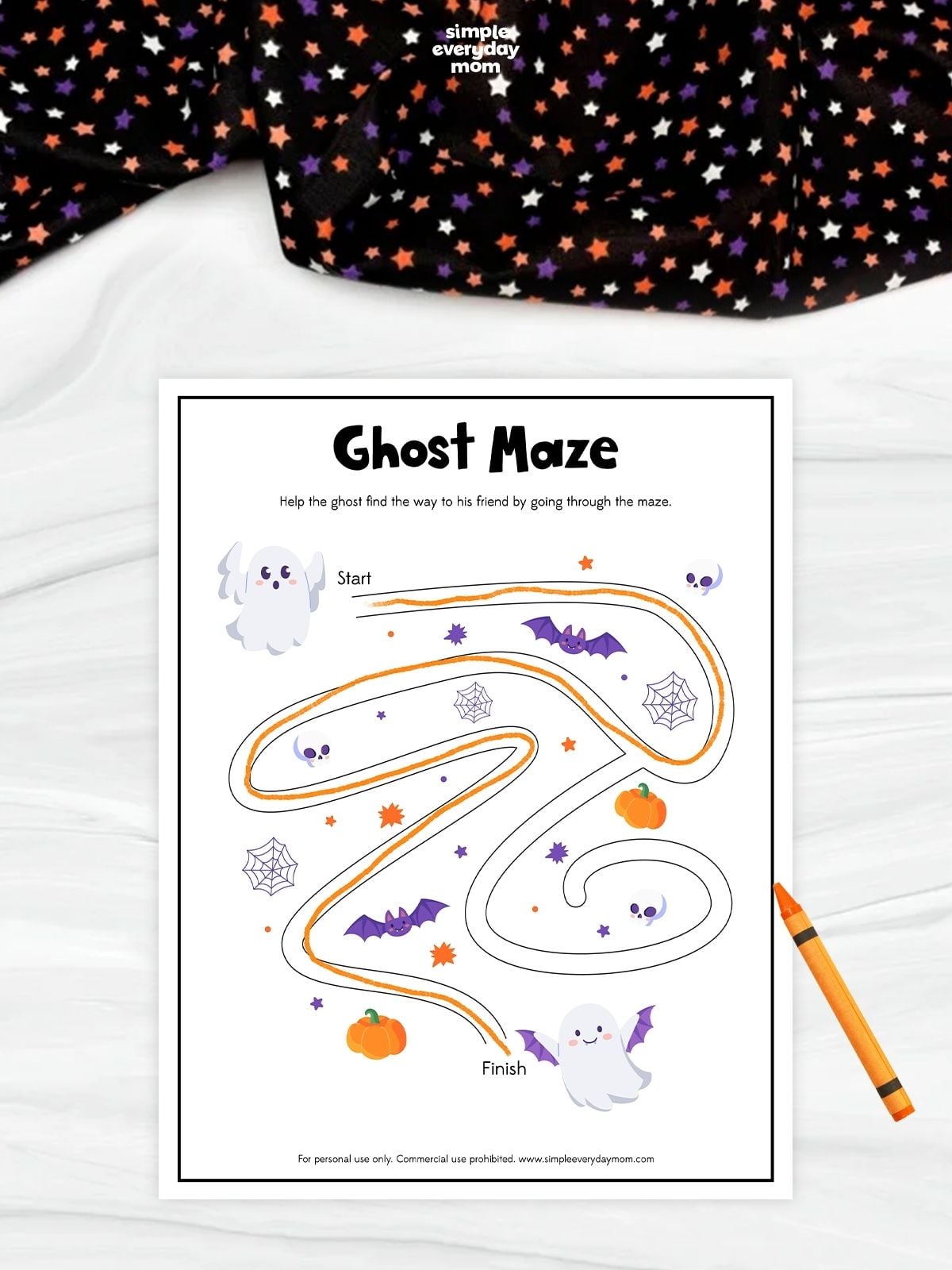 Printable ghost maze worksheet with bats, pumpkins, spiderwebs, and skulls for preschool fine motor skills and Halloween pencil practice.