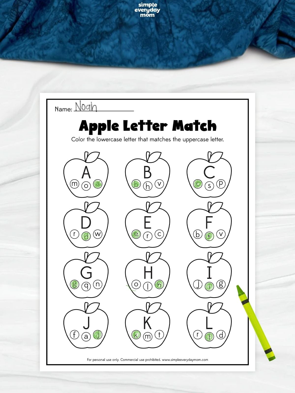 Apple letter matching worksheet with uppercase letters A–L inside apples and the corresponding lowercase letters colored green.