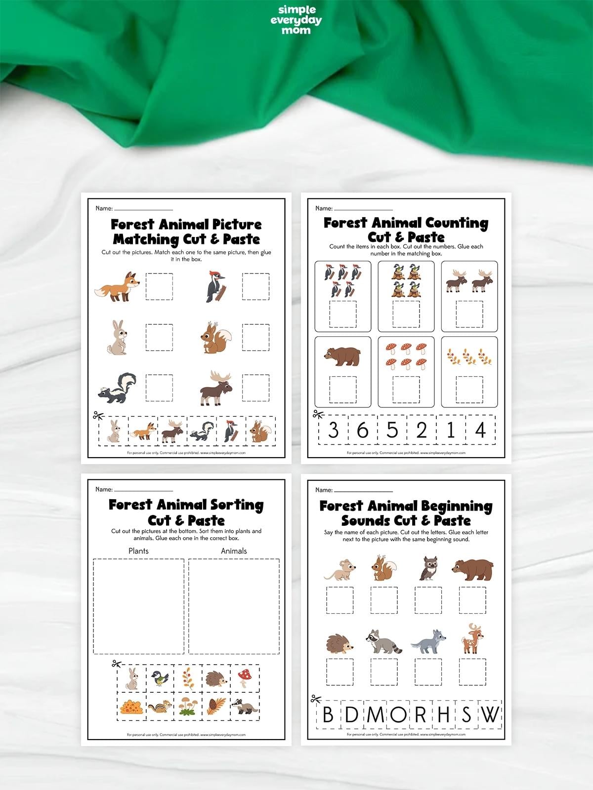 Four forest animal cut-and-paste worksheets featuring picture matching, counting, sorting plants and animals, and matching animals to their beginning sounds.