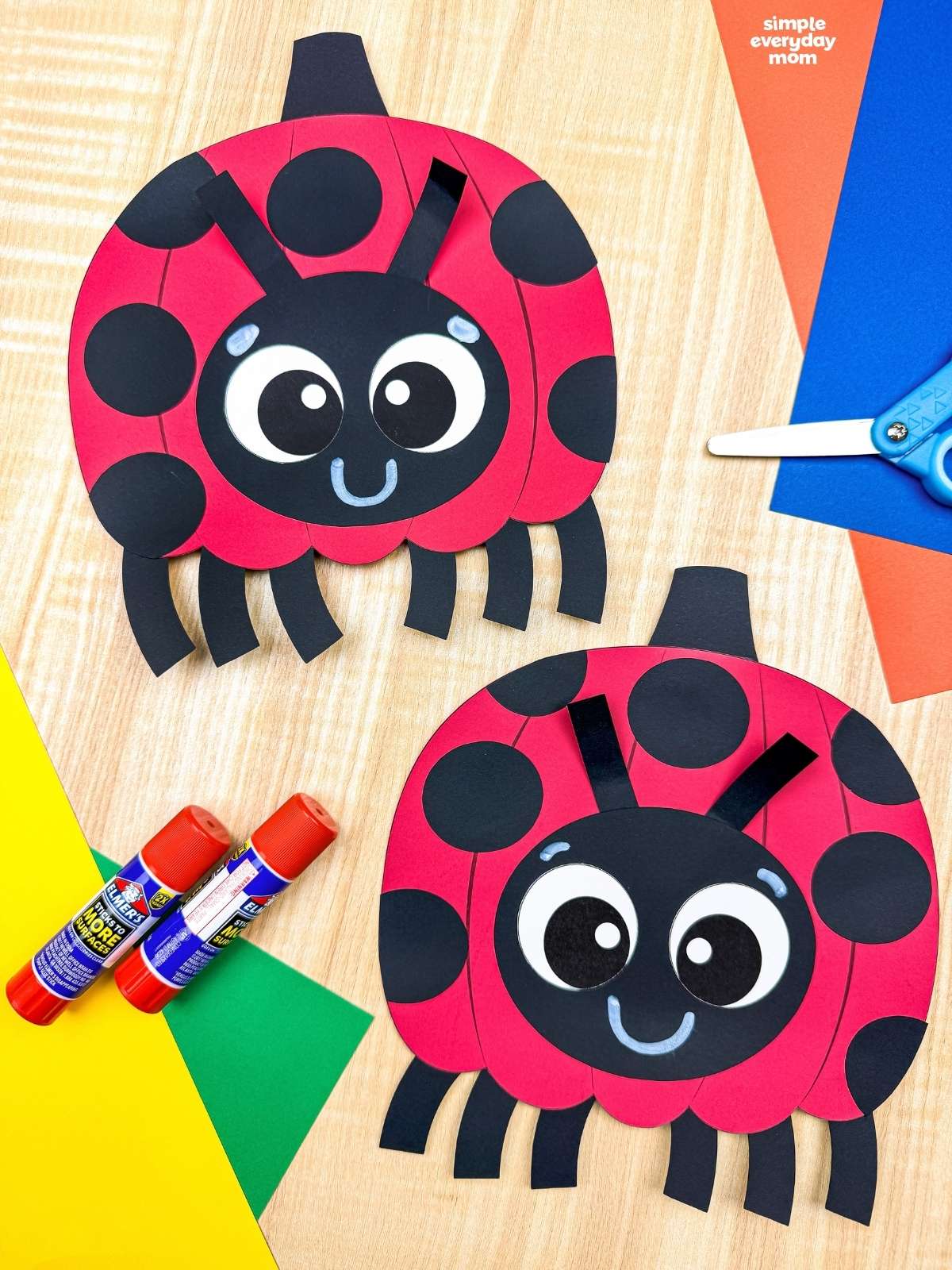 Side by side completed ladybug pumpkin crafts with black spots, smiling faces, antennae, and legs.