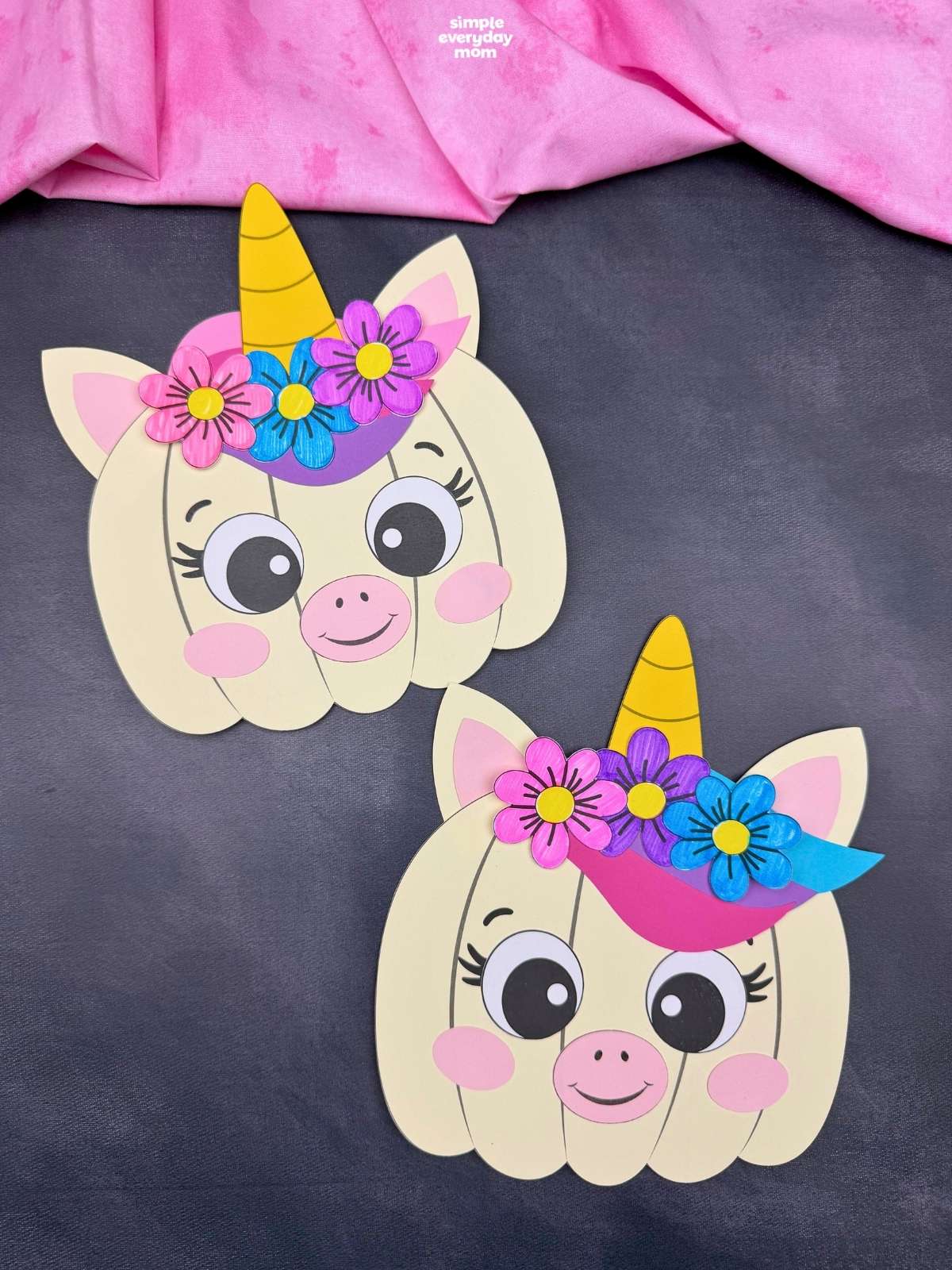 A completed craft showing two unicorn pumpkins decorated with horns, ears, colorful manes, and flowers.