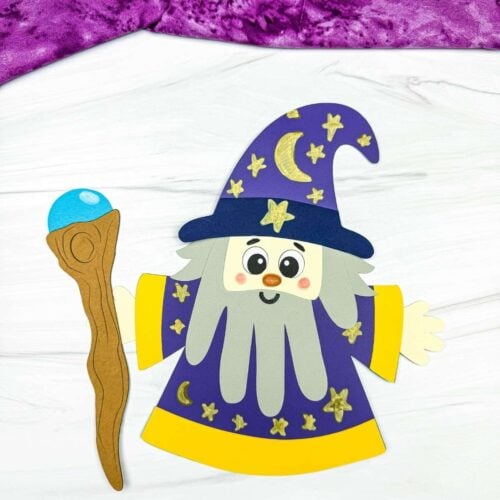 A completed Craft showing a Wizard Handprint Craft with a decorated hat, handprint beard, robe, and wizard staff.