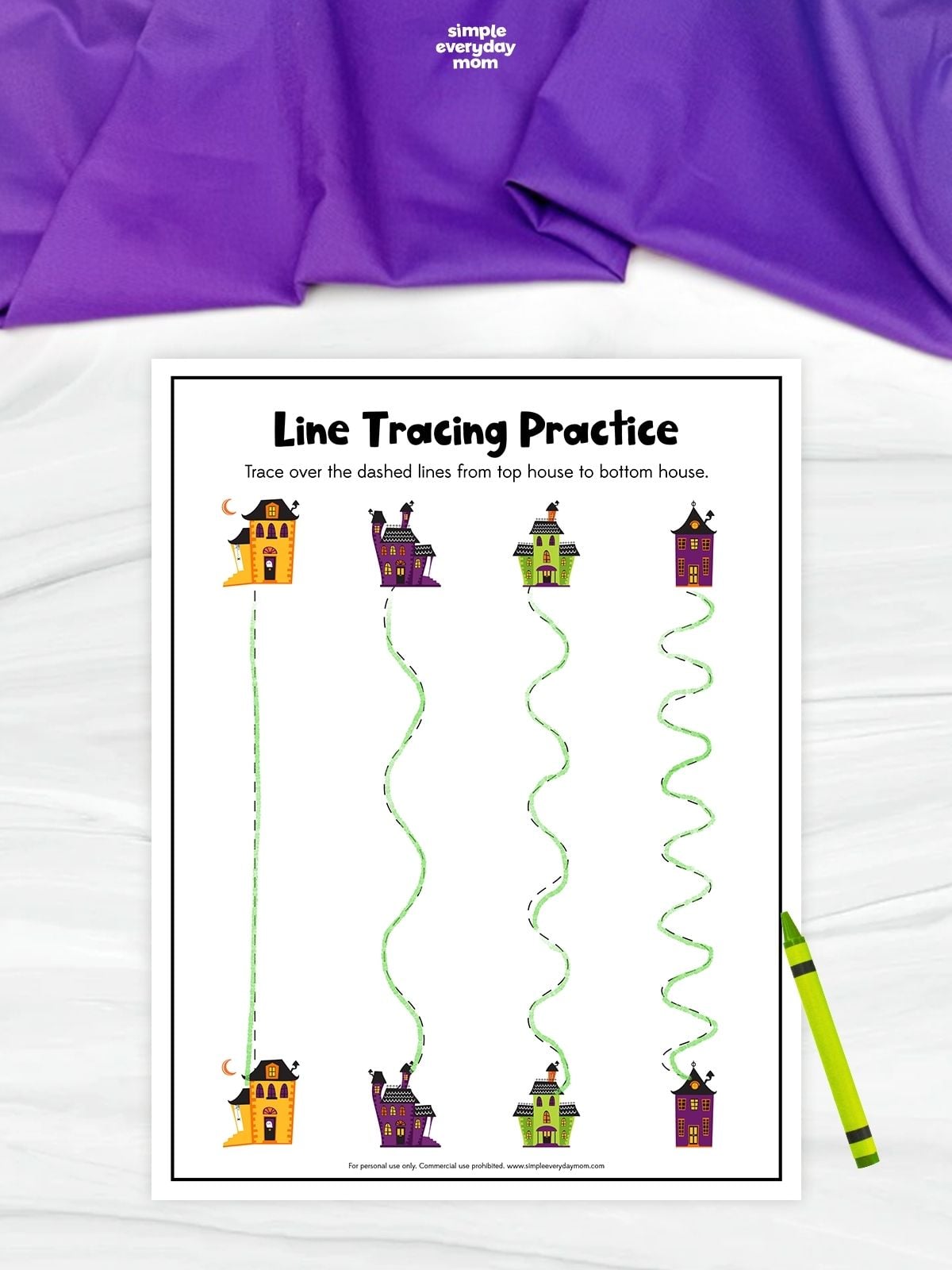 Line tracing practice worksheet featuring four pairs of colorful haunted houses connected by one straight and three wavy dashed paths. The paths have been traced in green from each top house to the matching house below.