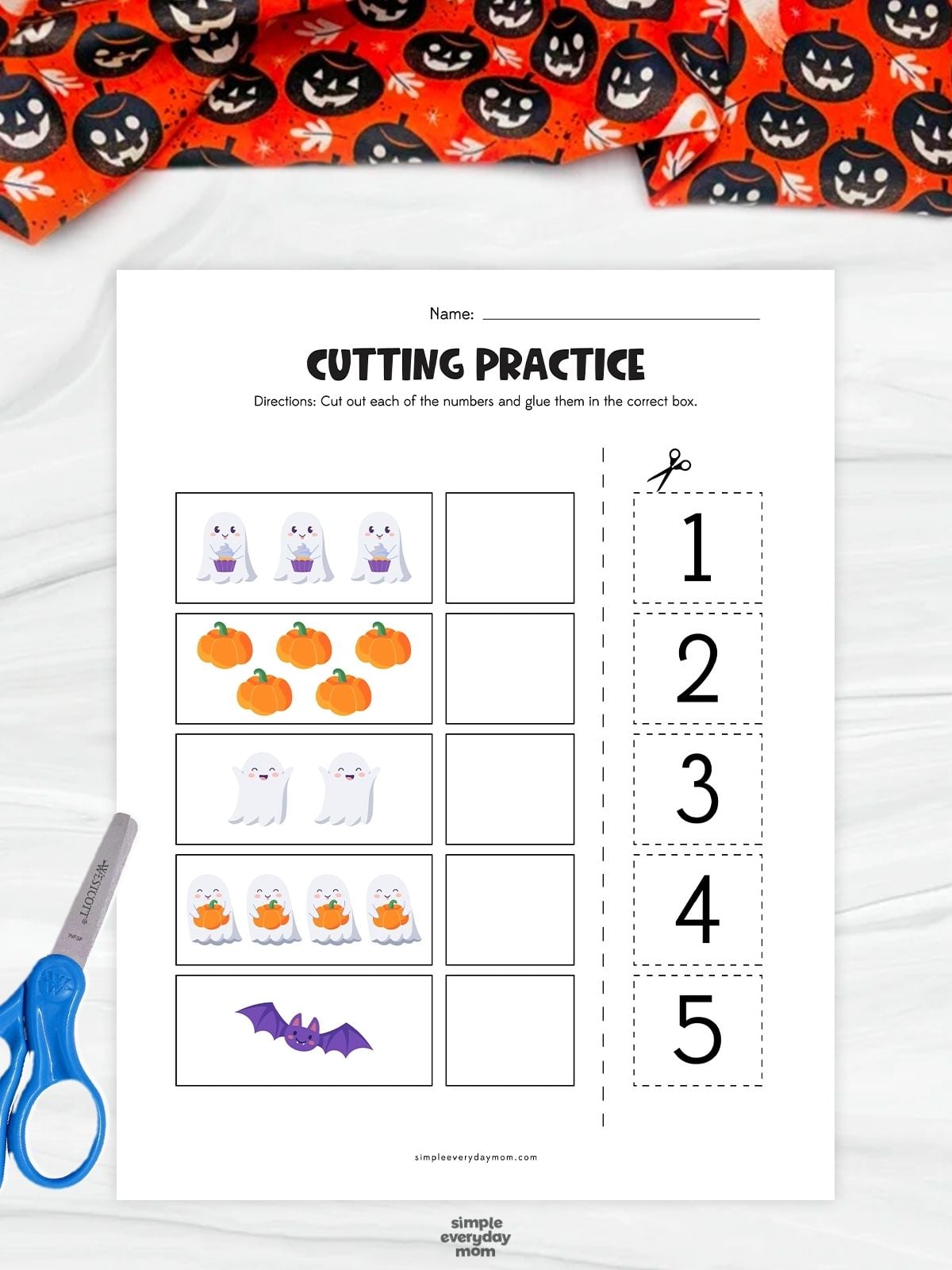 A completed ghost counting worksheet featuring Halloween pictures and cut out numbers 1 to 5 for kindergarten math and scissor practice.