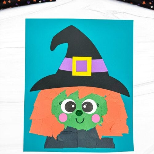 A completed Witch Torn Paper Craft featuring orange torn paper hair, a green face, pink cheeks, and a black witch hat on a blue background.