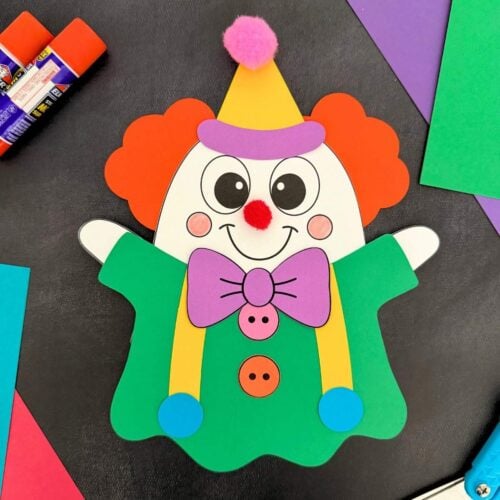A completed craft showing a colorful clown ghost disguise with orange hair, a yellow party hat, purple bow tie, and green outfit for a fun Halloween activity for kids.