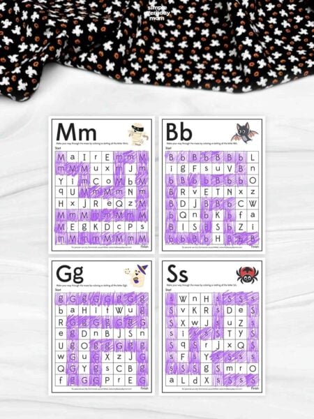 Four printable Halloween letter maze worksheets featuring mummy, bat, ghost, and spider designs with purple-colored letter paths for preschool and kindergarten alphabet learning activities.