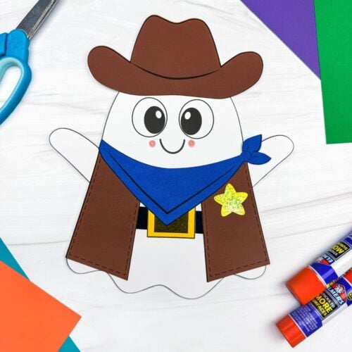 A completed Craft showing a Cowboy Ghost Disguise Craft with a cowboy hat, bandana, vest, belt, buckle, and star badge surrounded by craft supplies.
