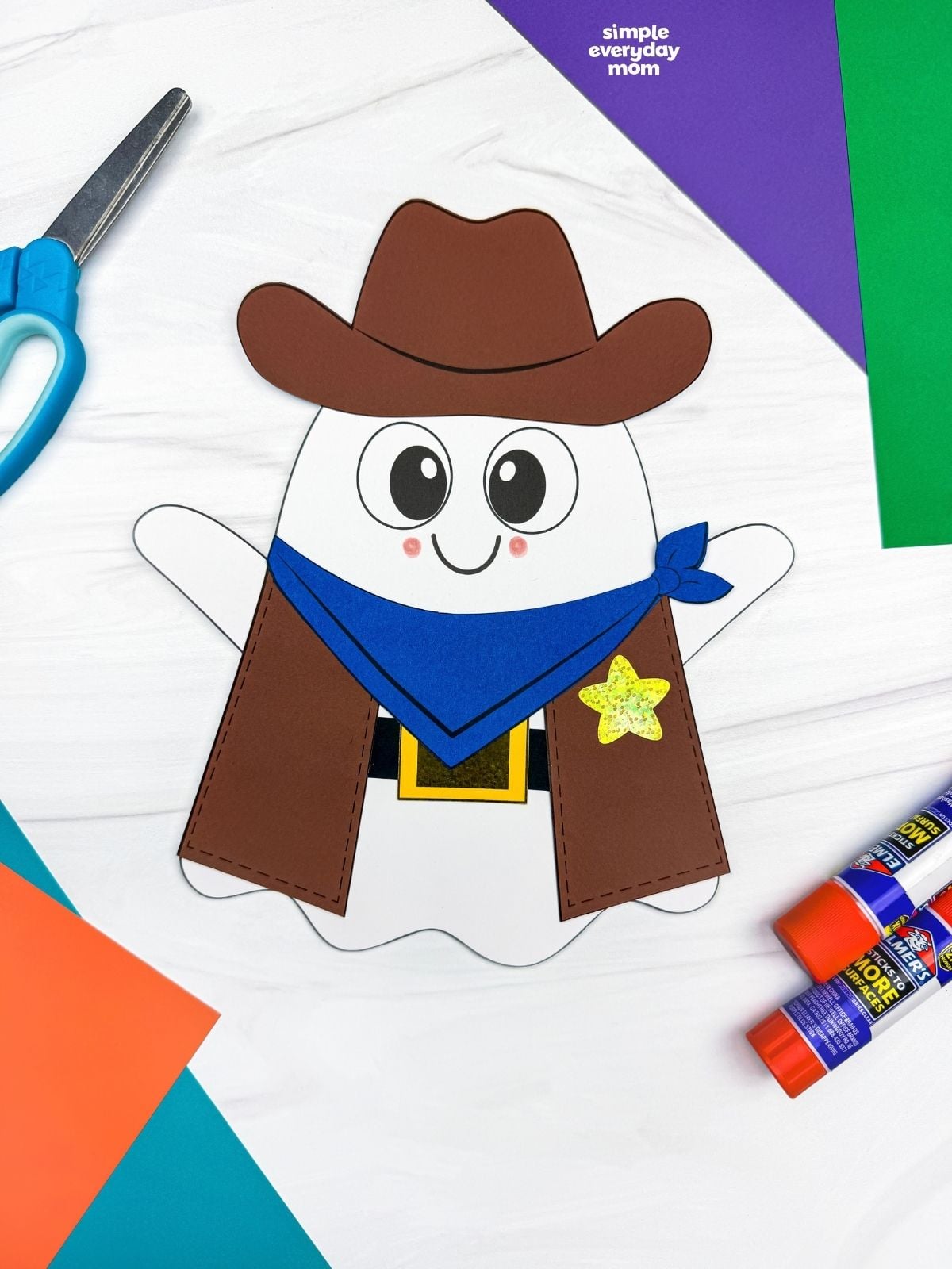 A completed Craft showing a Cowboy Ghost Disguise Craft with a cowboy hat, bandana, vest, belt, buckle, and star badge surrounded by craft supplies.