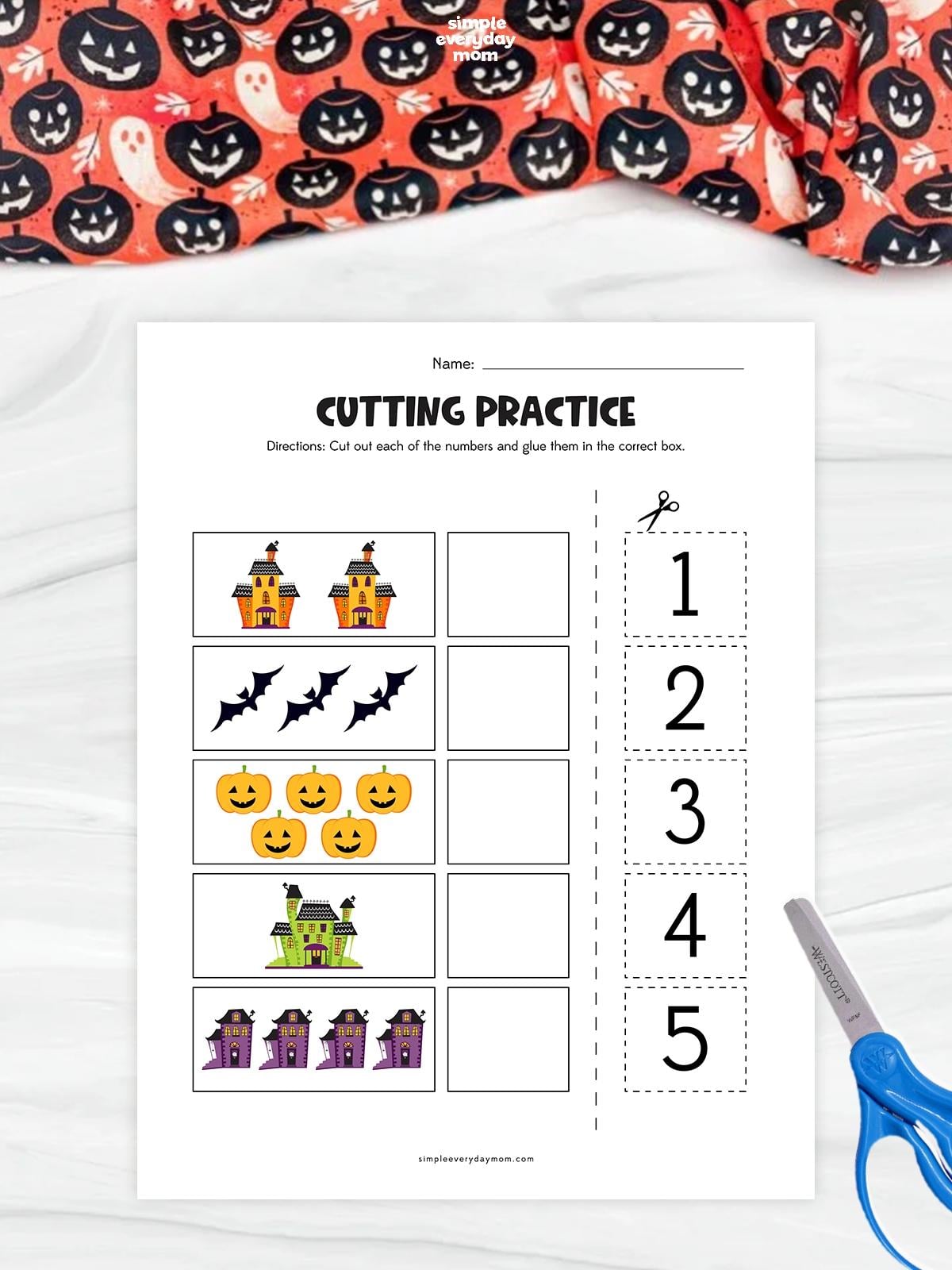 Halloween counting and cutting worksheet featuring haunted houses, bats, and pumpkins for kindergarten kids to practice number recognition, counting, and fine motor skills.