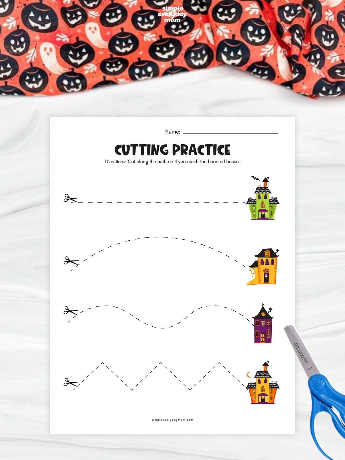 Printable haunted house cutting practice worksheet featuring straight, curved, wavy, and zigzag lines for preschoolers to develop scissor skills and fine motor coordination.