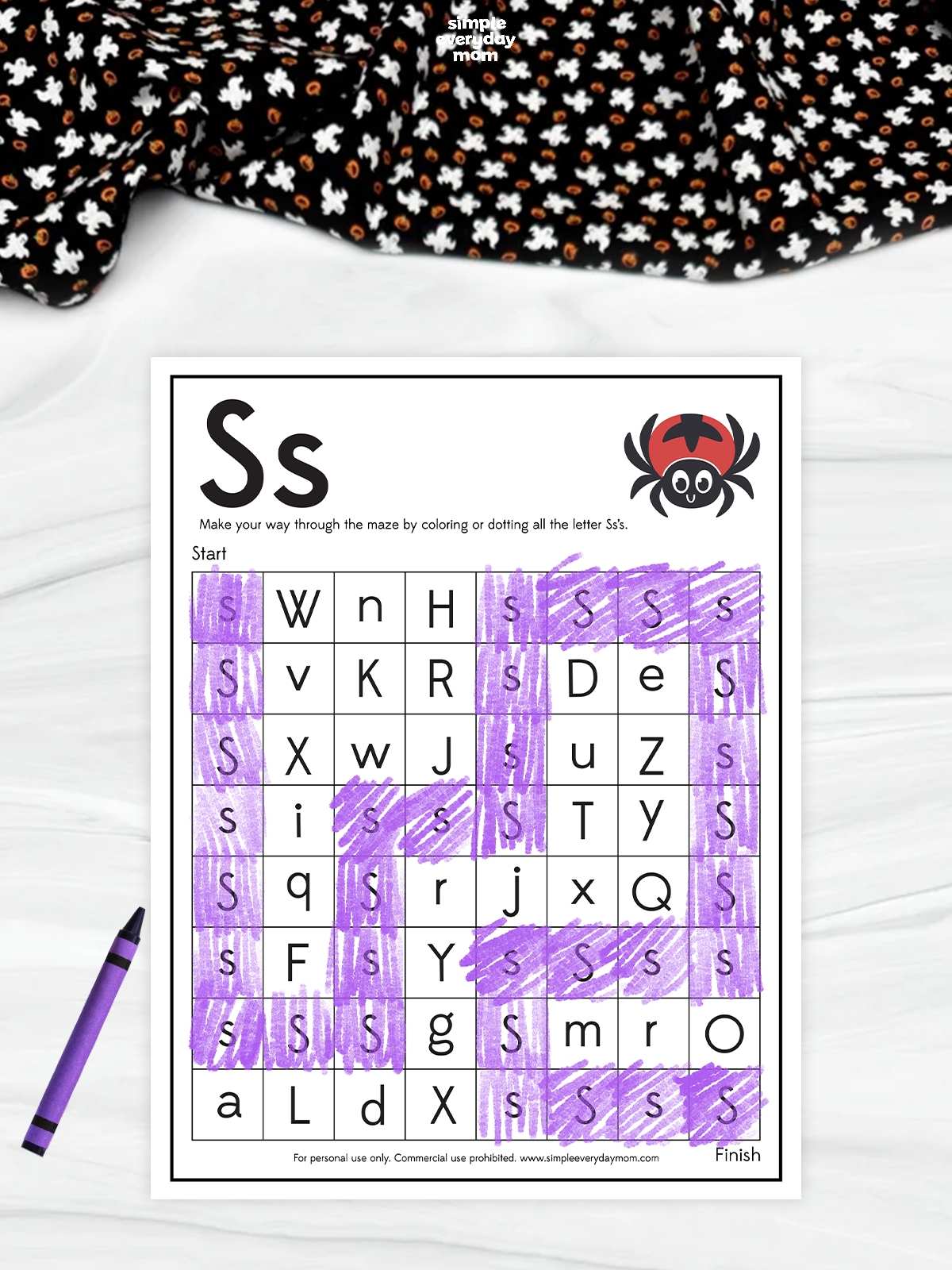 A Halloween letter S maze worksheet featuring a cute spider and purple-colored uppercase and lowercase S letters for kindergarten alphabet recognition and fine motor skills practice.